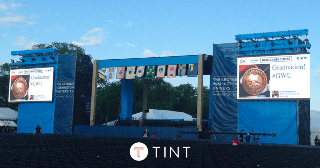 TINT social display visible on screens at George Washington University graduation stage