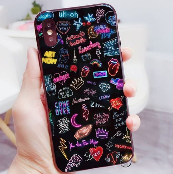 Teen girl holding black phone case with hand drawn doodles