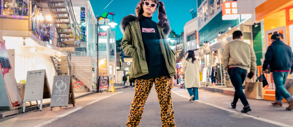 A trendy woman posing in the middle of the road