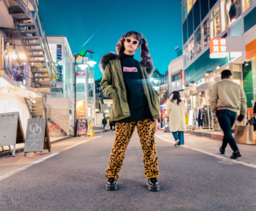 A trendy woman posing in the middle of the road