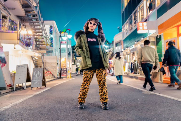 A trendy woman posing in the middle of the road