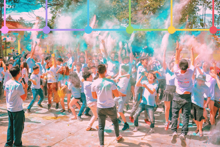 People engaging at holi event with graphical overlay if six colored logos