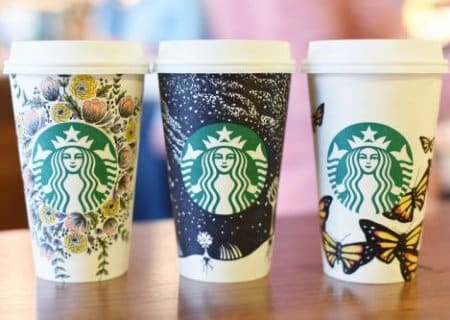 Three Starbucks' cups with hand-drawn illustrations for white cup UGC campaign