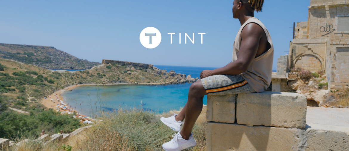 Man sitting on a ledge overlooking the ocean