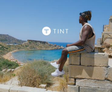 Man sitting on a ledge overlooking the ocean