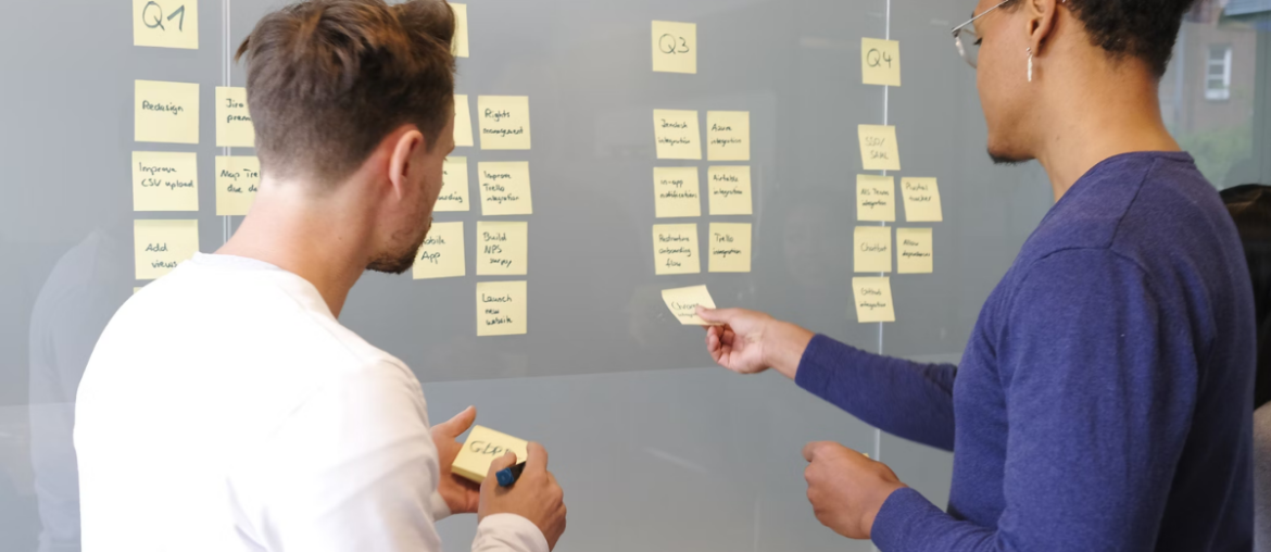 two people brainstorming with sticky notes