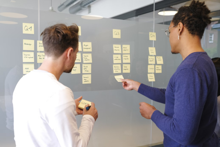 two people brainstorming with sticky notes