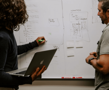 Two people collaborating on a whiteboard