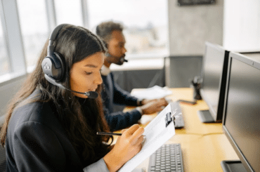 Customer service rep writing notes