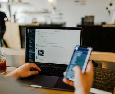 A man on his laptop and cellphone at the same time