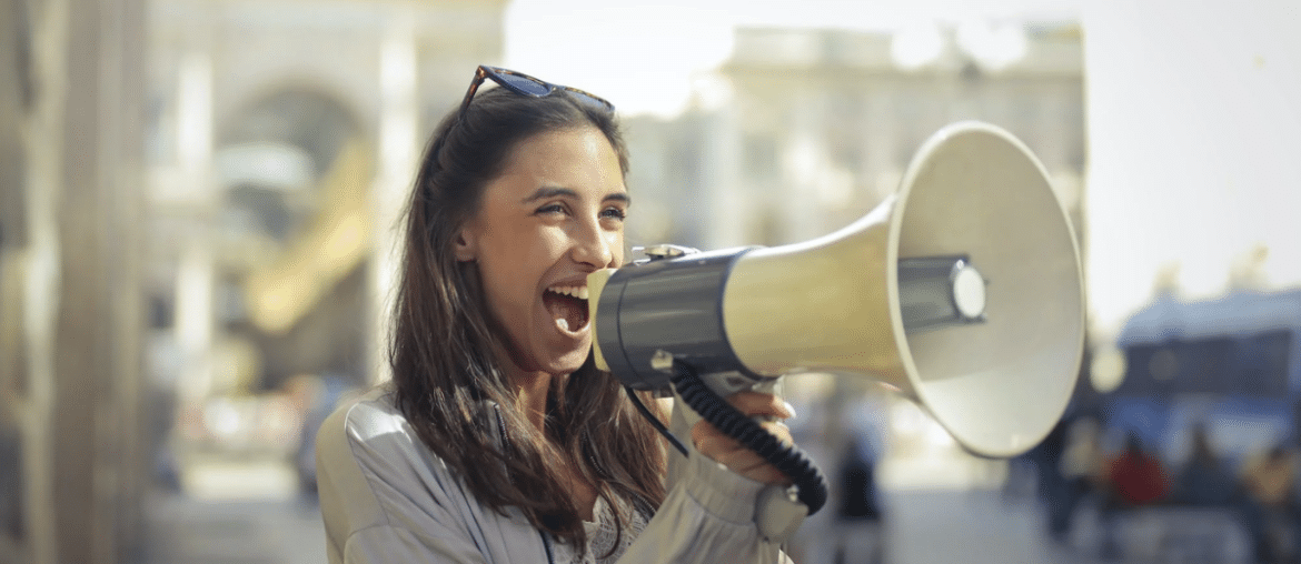 A woman speaking into a megaphone