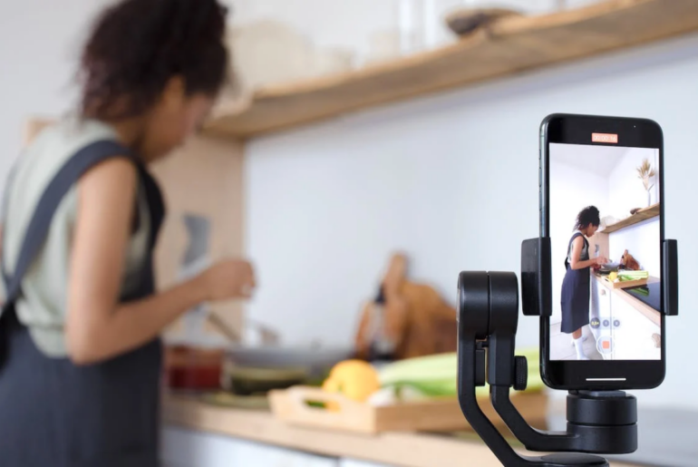 A woman filming herself cooking