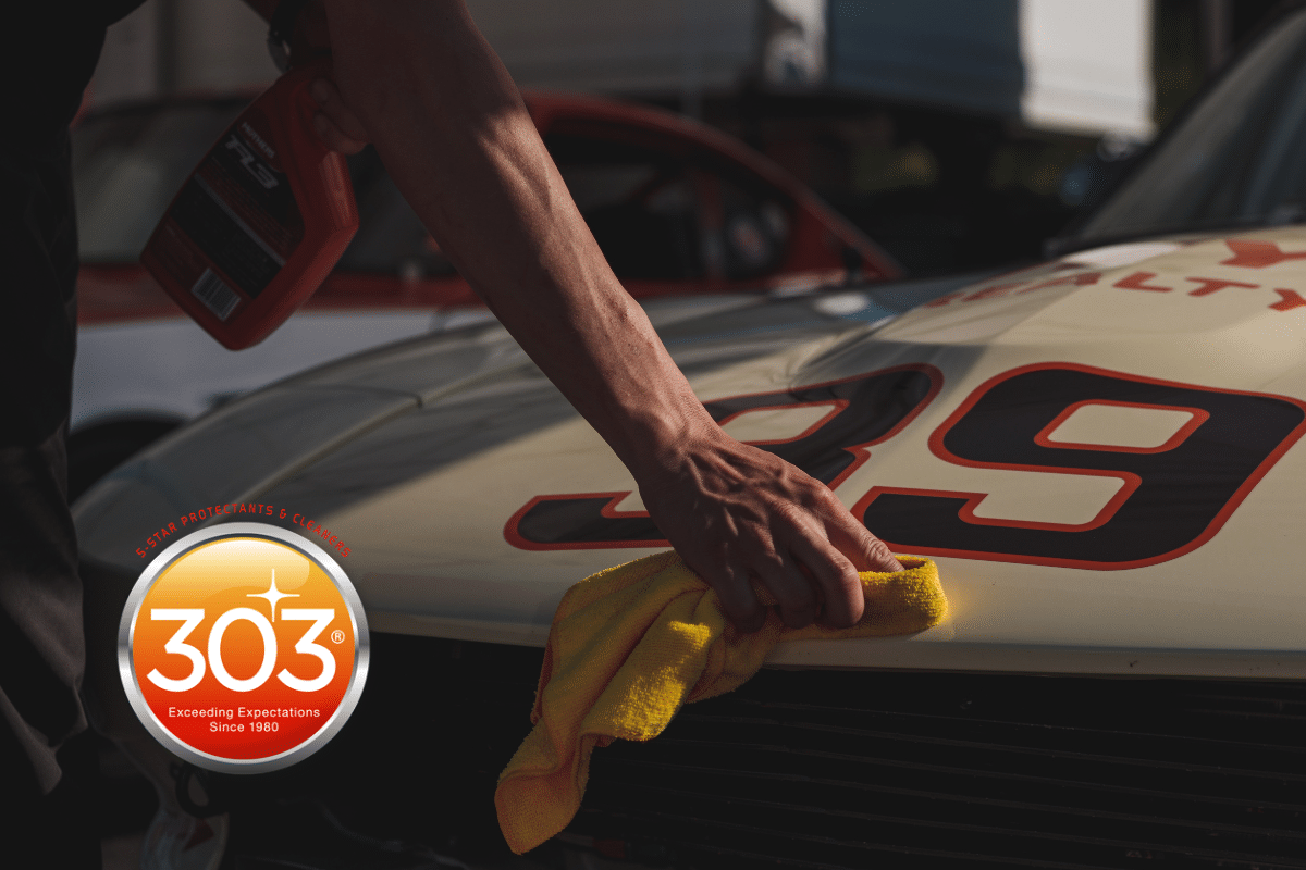 303 - a person cleaning a race car