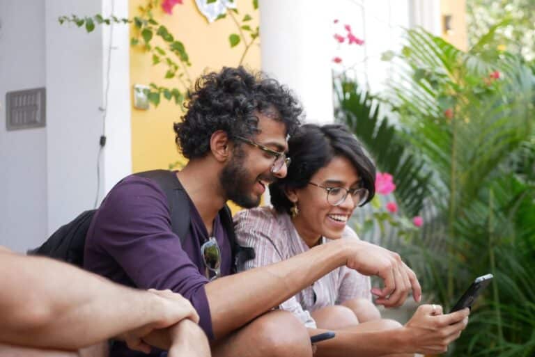 A man and woman looking at a phone