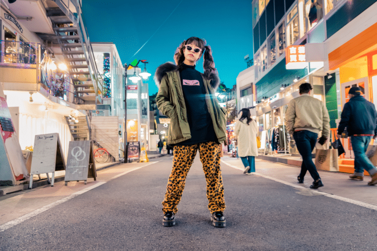 A trendy woman posing in the middle of the street