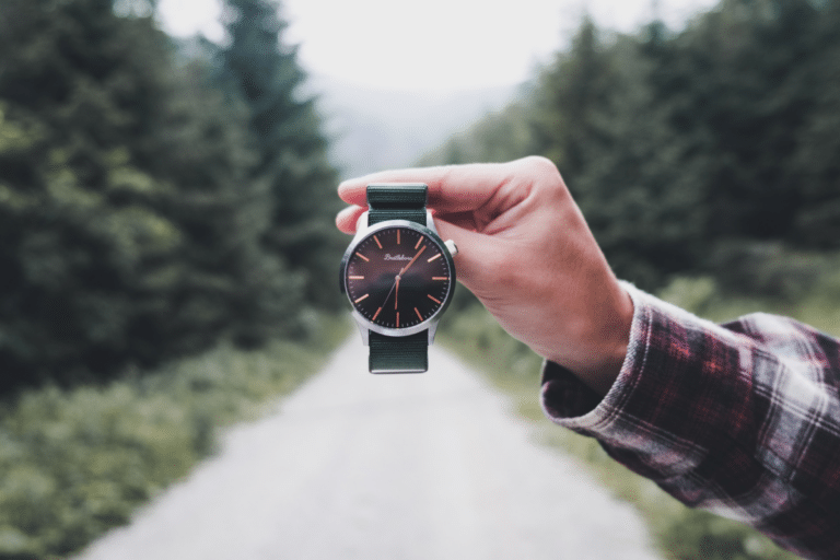 A watch with a forest in the background