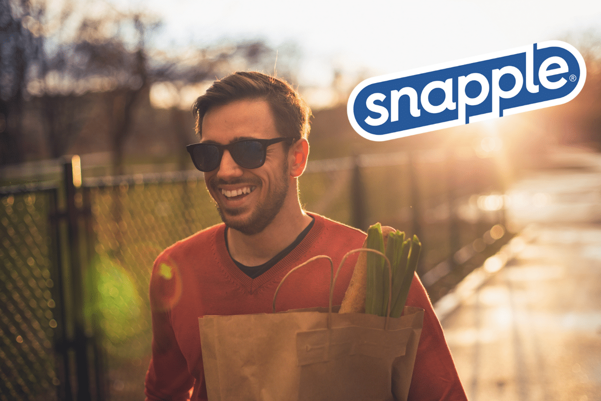 A man holding a grocery bag – featuring a Snapple logo on the image