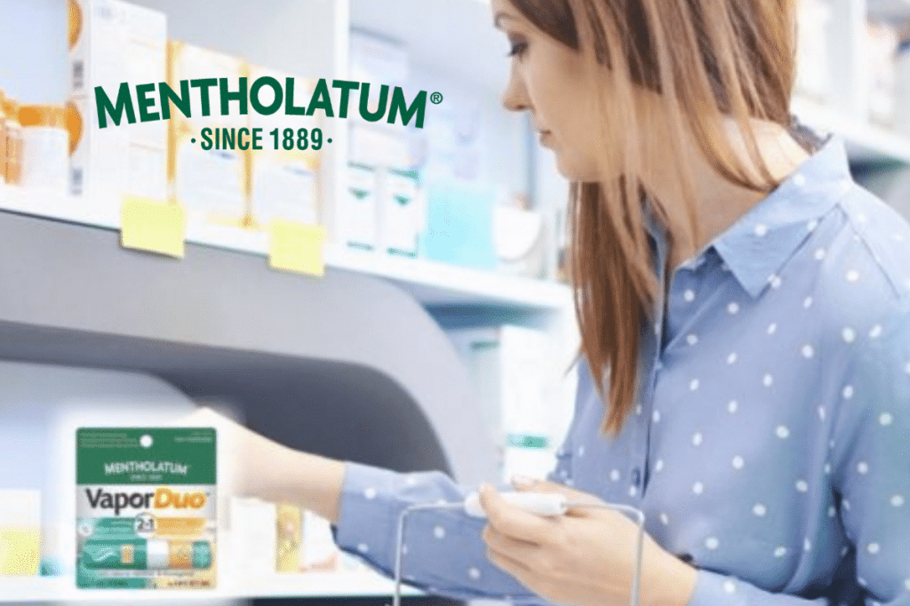 Woman in pharmacy with Mentholatum logo