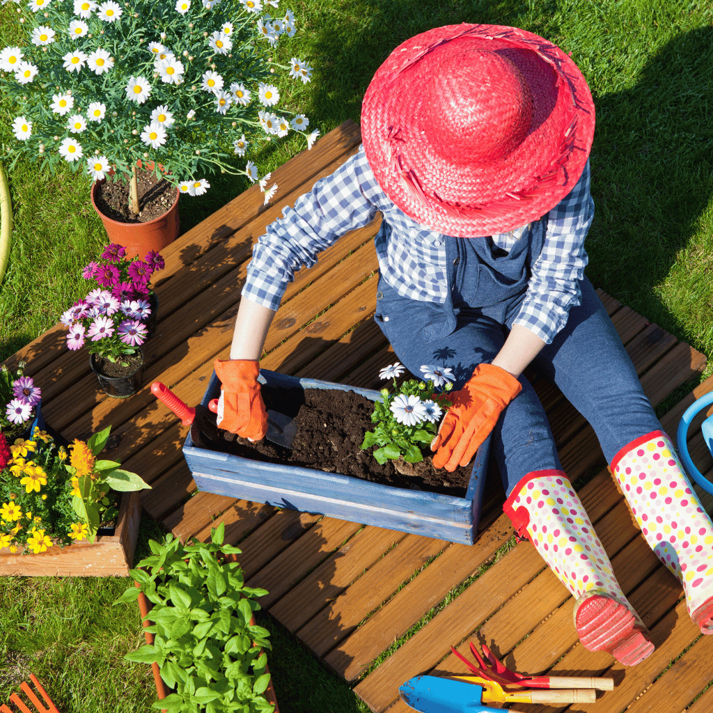 Woman wearing boots and red hat in gardening
