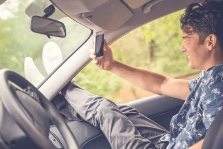 A man taking a selfie in the car